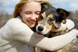 Close up of Woman Hugging German Shepherd Dog